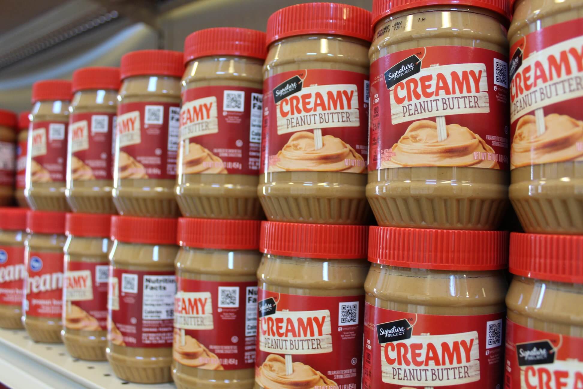 Jars of Peanut Butter stacked on a shelf