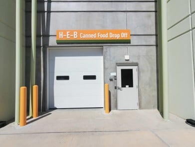 White garage door with orange sign with white text
