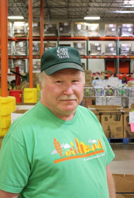 Older white man with white mustache in a green t-shirt and North Texas Food Bank baseball cap