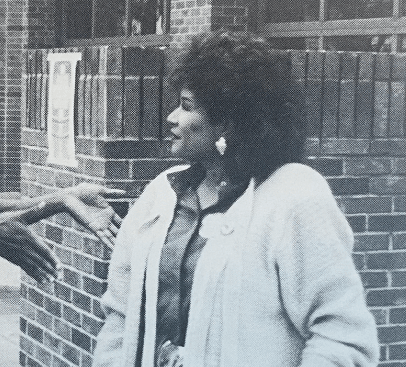 Black and white photo of a black woman standing outside in 1987