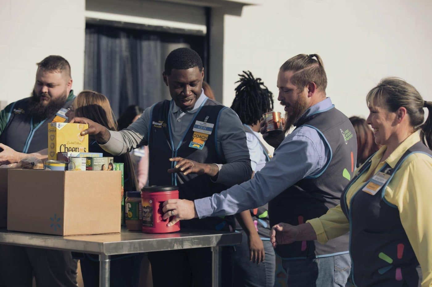 Group of people packing food into a box