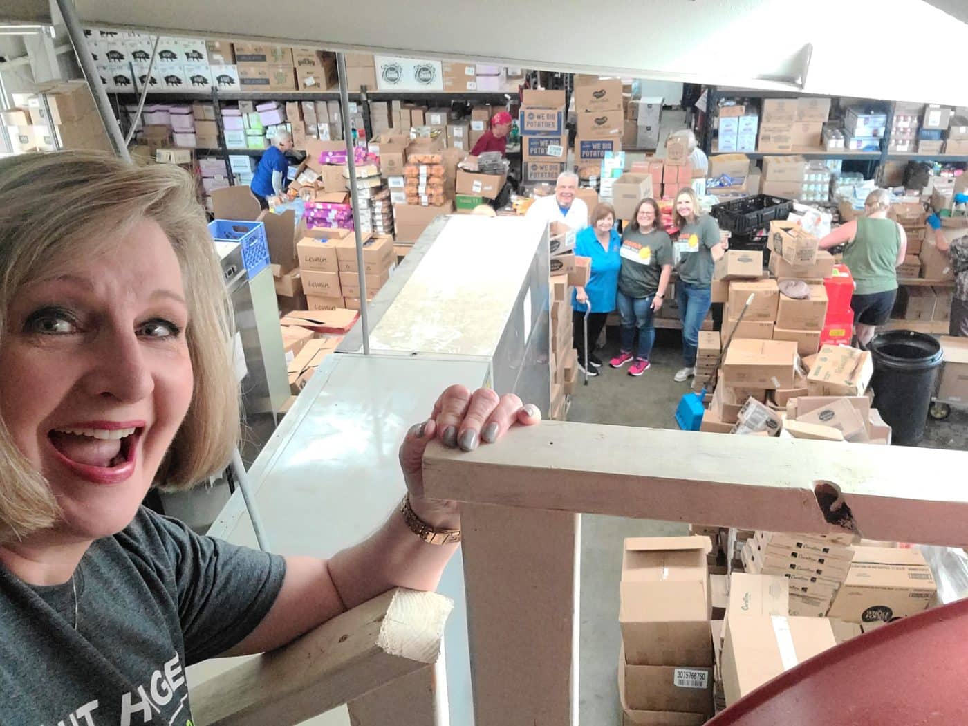 Group of people in warehouse with boxes