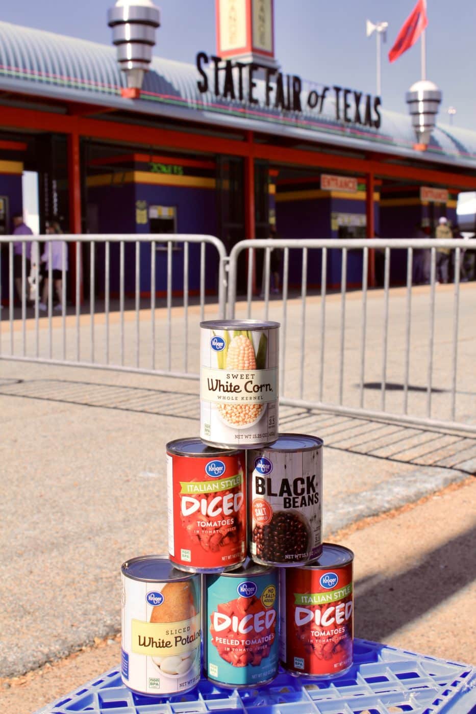 Stacked canned foods in front of State Fair of Texas entry gate