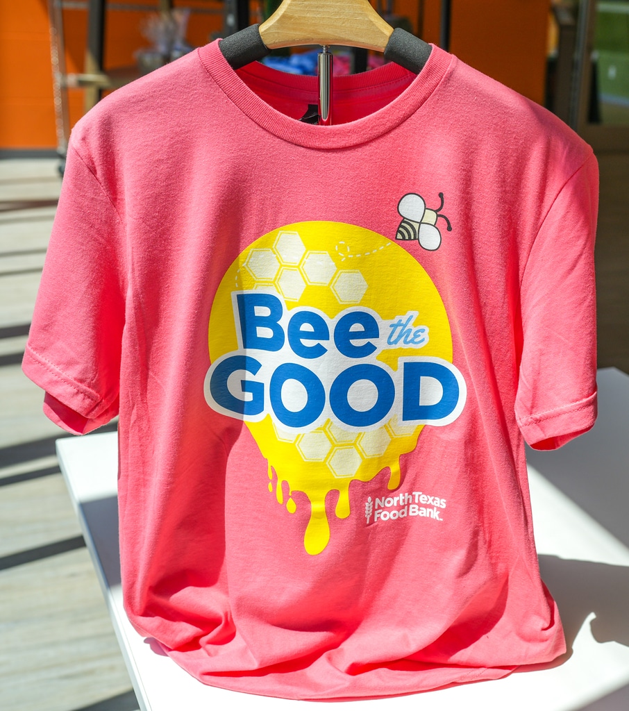 Pink short with Bee The Good on it in the North Texas Food Bank online store.