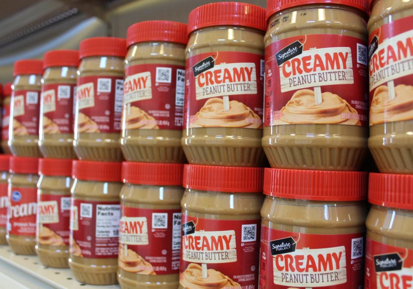 Jars of Peanut Butter stacked on a shelf