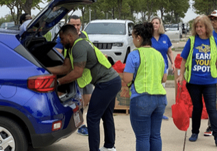 Volunteers pack one of many cars for food distribution throughout North Texas areas.
