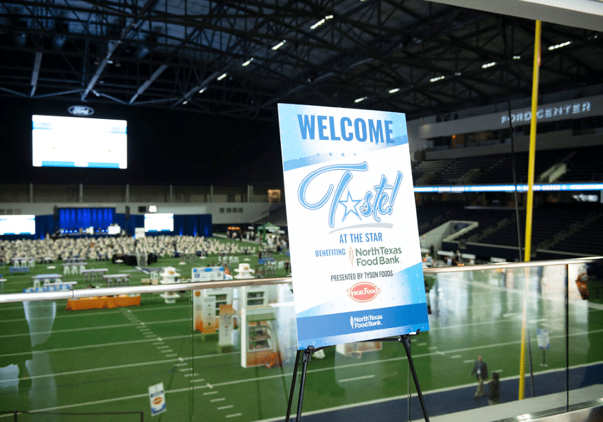 A sign advertising Taste at the Star with a football background.